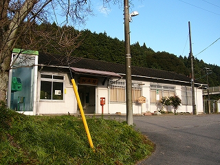 電話ボックスと冬枯れした大きな木と駅舎。