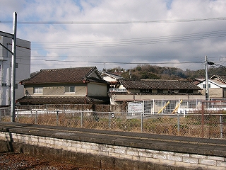 レンガ積みのホームと古い２つの民家。