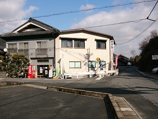灰色の民家風の建物と白い建物。